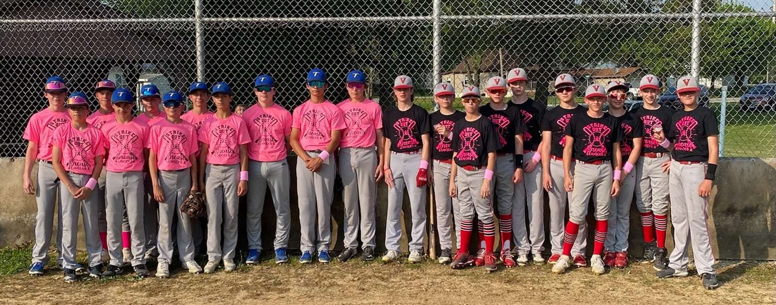 21 teenage boys in pink and black tee shirts, gray baseball pants, cleats, sunglasses, and ball caps