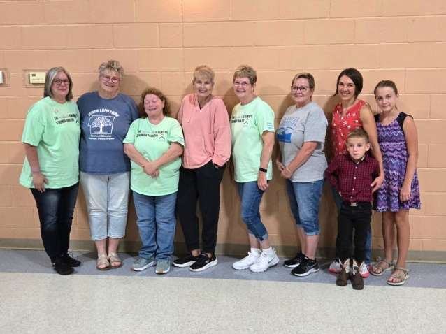 lineup of women and a child representing helpers for a charity event